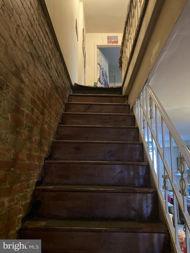 staircase with brick wall