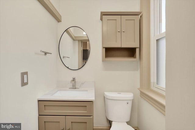 bathroom with toilet and vanity