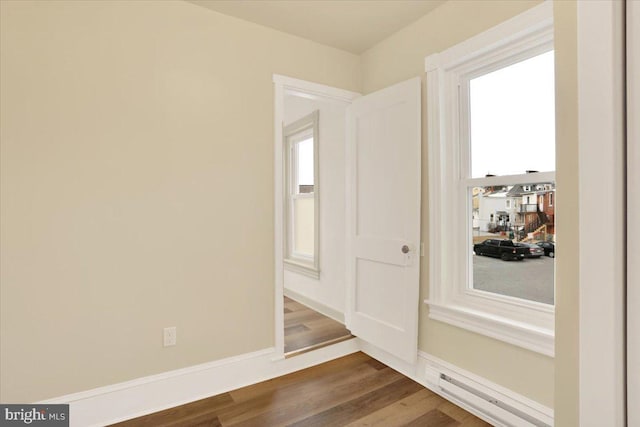 interior space with baseboards and wood finished floors