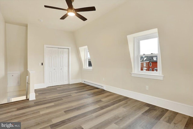 unfurnished bedroom featuring a closet, wood finished floors, visible vents, and baseboards