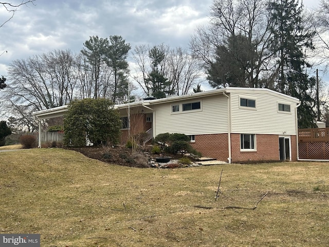 exterior space featuring brick siding and a front lawn