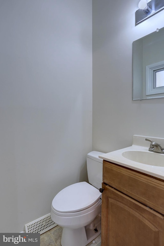 bathroom with tile patterned flooring, visible vents, toilet, and vanity