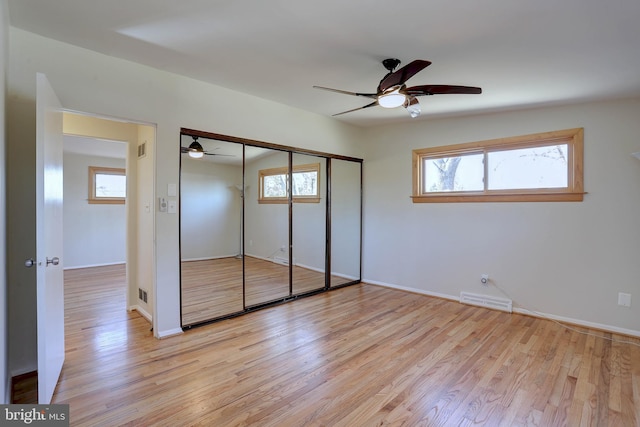 unfurnished bedroom featuring light wood-style flooring, multiple windows, and visible vents