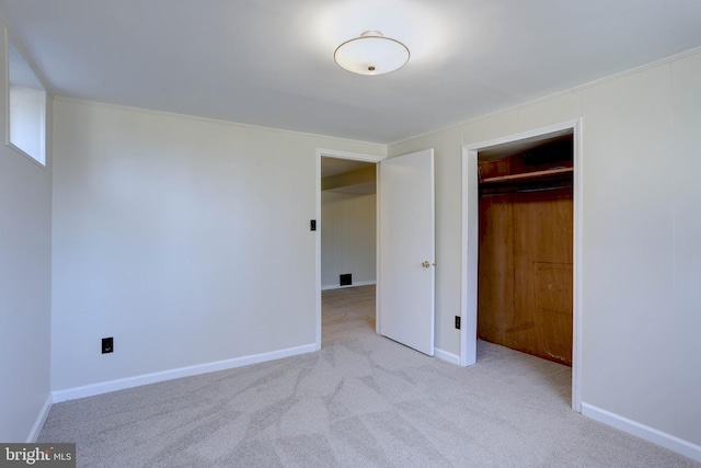 unfurnished bedroom with a closet, baseboards, and carpet flooring