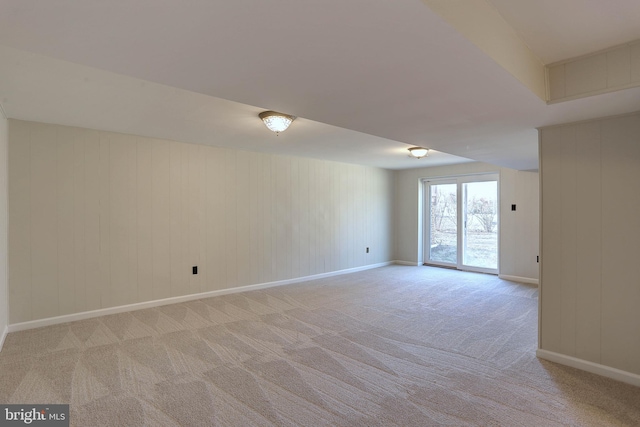 empty room featuring light carpet and baseboards