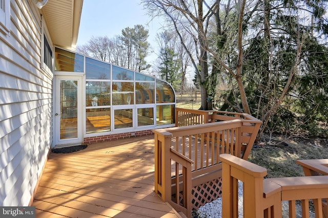 wooden deck with a sunroom