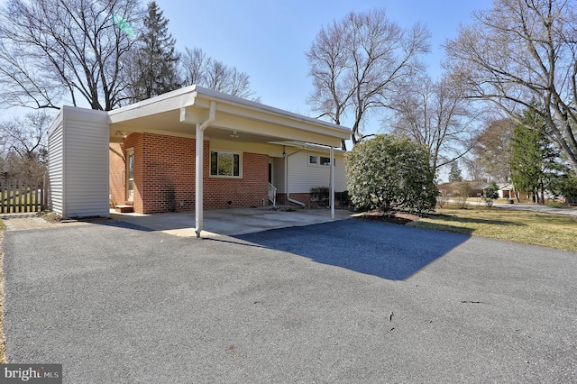 view of parking / parking lot featuring entry steps and driveway