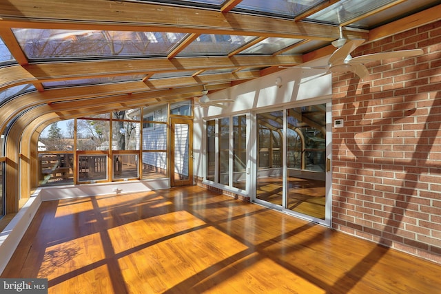 unfurnished sunroom featuring a skylight