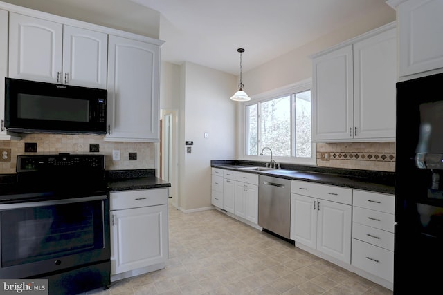 kitchen with white cabinetry, black appliances, dark countertops, and a sink