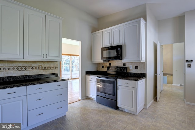 kitchen featuring tasteful backsplash, white cabinets, stainless steel range with electric stovetop, and black microwave