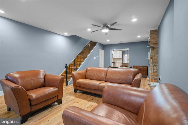 living room with ceiling fan and light wood-type flooring