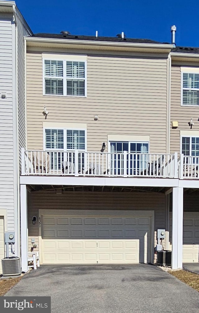 back of property featuring a garage and driveway