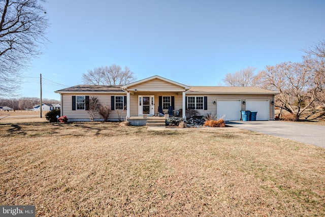 ranch-style house featuring driveway, a garage, a front lawn, and a porch