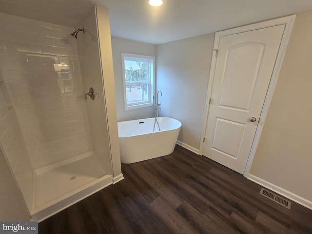 bathroom featuring independent shower and bath and wood-type flooring