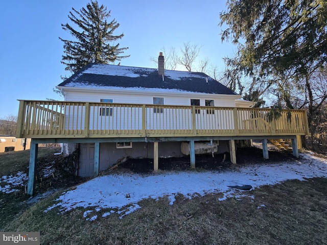 snow covered rear of property featuring a wooden deck