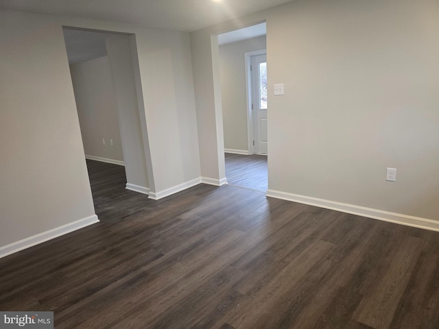 spare room with dark hardwood / wood-style flooring