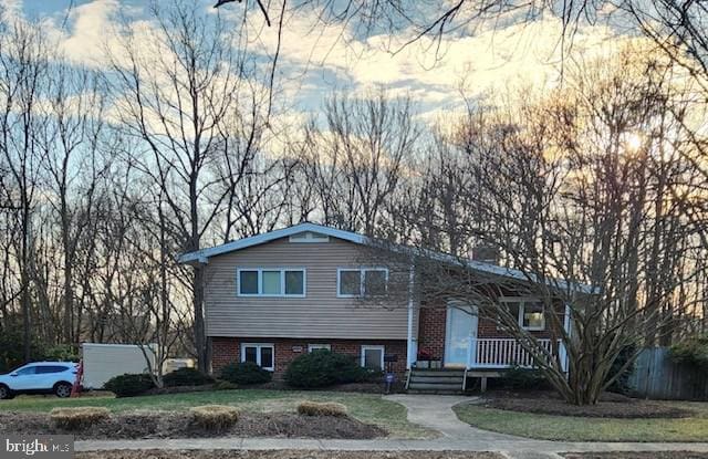 view of front of property featuring brick siding and covered porch