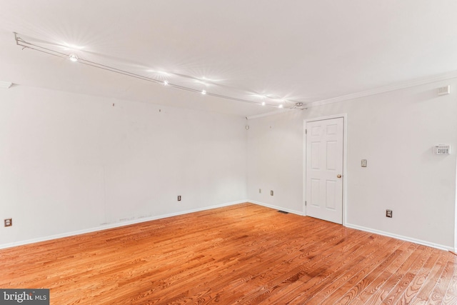 empty room with light wood-style flooring and baseboards