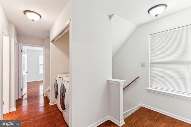 washroom with laundry area, baseboards, washer and clothes dryer, and dark wood finished floors