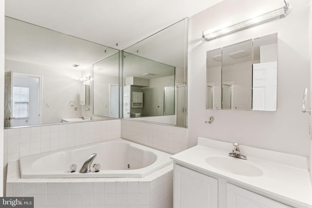 full bath with a jetted tub and vanity