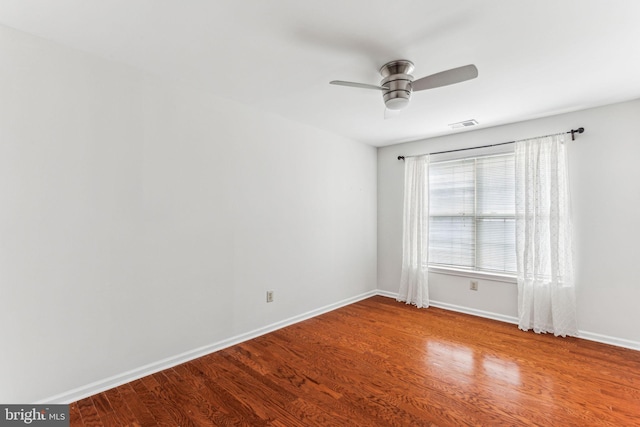 unfurnished room featuring visible vents, ceiling fan, baseboards, and wood finished floors