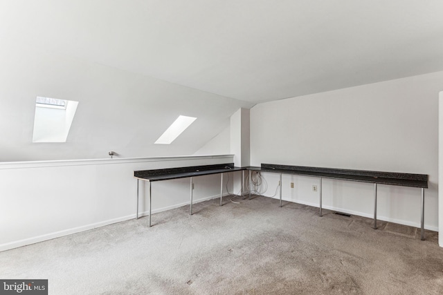 bonus room with carpet floors, lofted ceiling with skylight, and baseboards