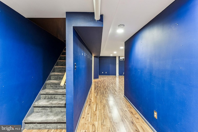 stairway with baseboards and wood finished floors