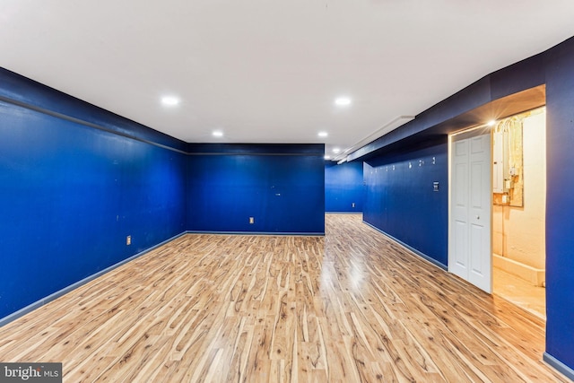 unfurnished room featuring baseboards, wood finished floors, and recessed lighting