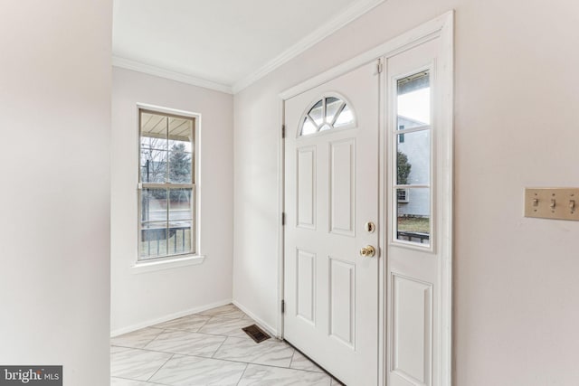 foyer featuring a wealth of natural light, marble finish floor, visible vents, and crown molding