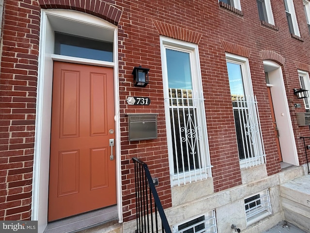 property entrance featuring brick siding