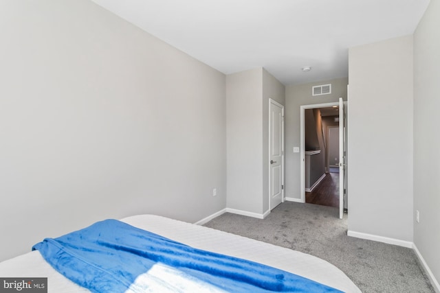 bedroom with baseboards, visible vents, and carpet flooring