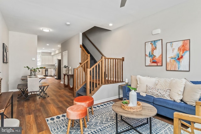 living area with dark wood-type flooring, recessed lighting, stairway, and baseboards