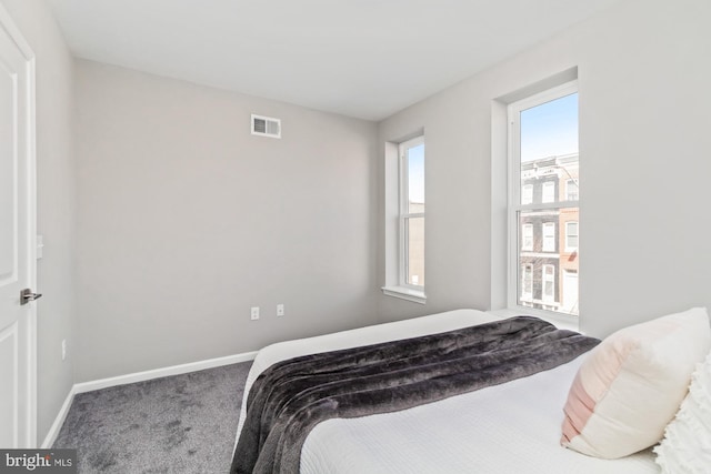 carpeted bedroom featuring visible vents and baseboards