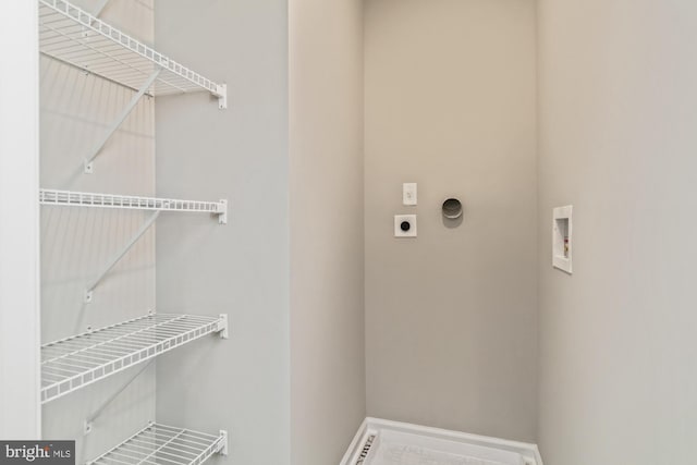 clothes washing area with hookup for a washing machine, laundry area, hookup for an electric dryer, and baseboards