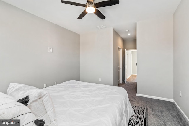 bedroom featuring dark colored carpet, visible vents, ceiling fan, and baseboards