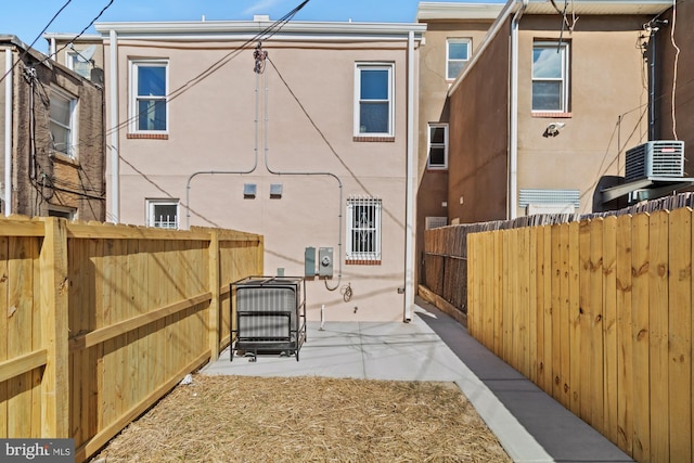 back of house featuring a patio area, fence, and stucco siding