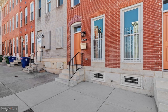 property entrance with brick siding