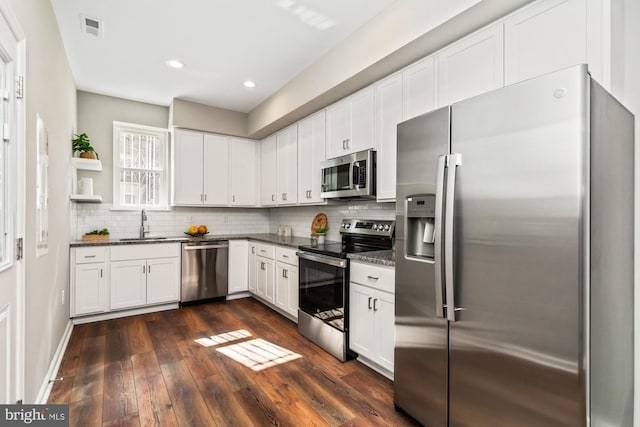 kitchen with open shelves, stainless steel appliances, tasteful backsplash, visible vents, and white cabinets