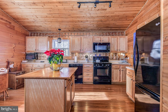 kitchen with pendant lighting, black appliances, and light brown cabinets