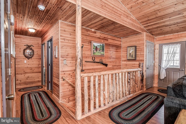 interior space featuring hardwood / wood-style flooring, wood ceiling, vaulted ceiling, and wooden walls
