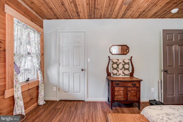 bedroom featuring wood-type flooring and wooden ceiling