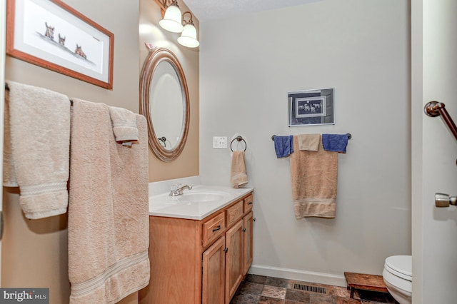 bathroom with toilet and vanity