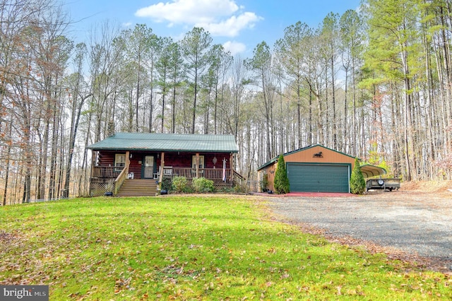 ranch-style house with covered porch, a garage, a front lawn, and an outdoor structure