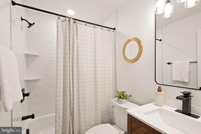 bathroom featuring toilet, shower / tub combo, and vanity