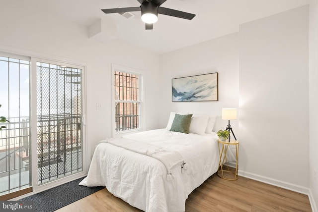 bedroom with ceiling fan, wood finished floors, access to exterior, and baseboards