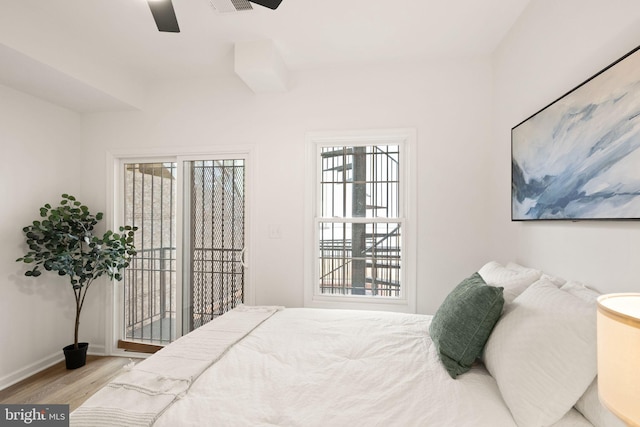 bedroom with access to exterior, ceiling fan, baseboards, and wood finished floors