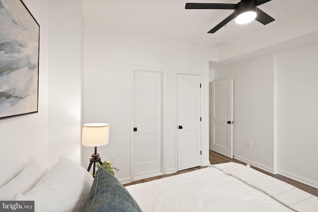 bedroom featuring ceiling fan, wood finished floors, and baseboards