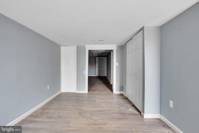 spare room featuring light wood-type flooring