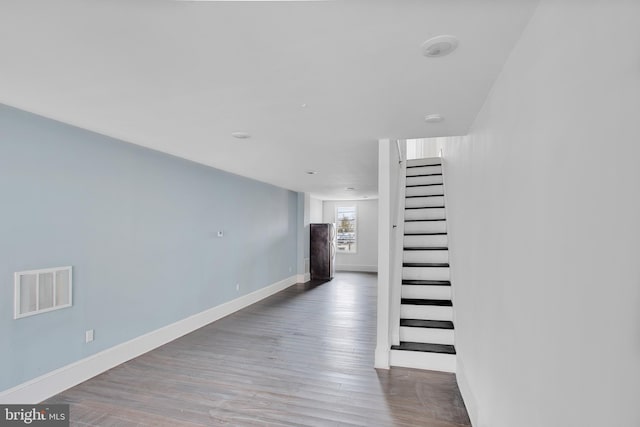 hallway with wood-type flooring