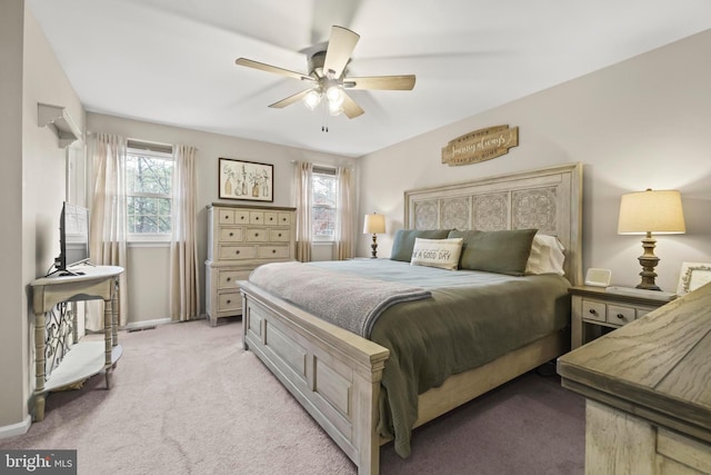 bedroom featuring ceiling fan and light carpet